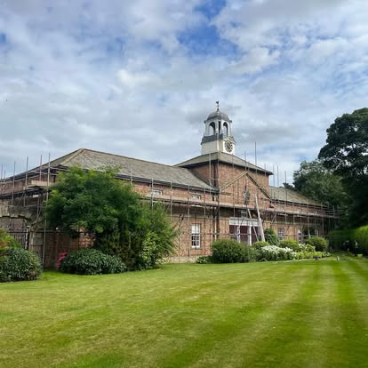 Heritage country house with scaffolding wrapping the side elevation
