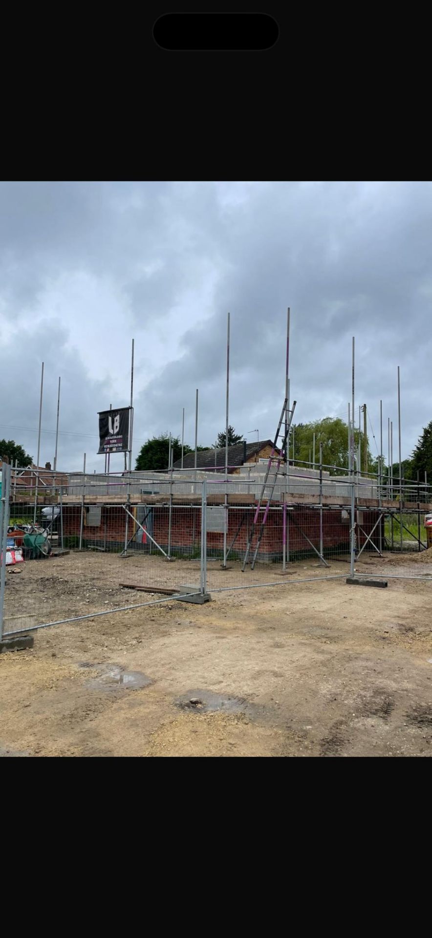 New build at first-lift stage with scaffold standards erected around block walls