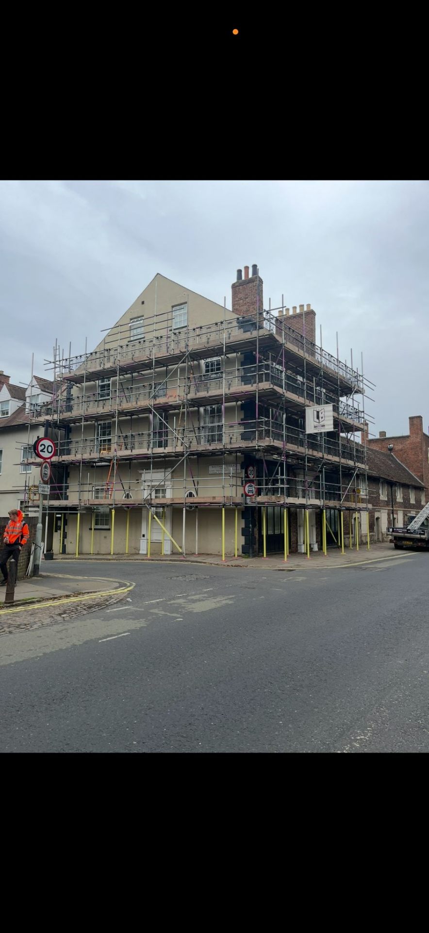 Four-storey corner building in York with full elevation scaffolding for facade works