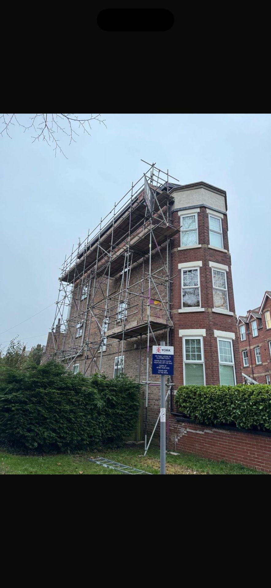 Red-brick Victorian villa in York with scaffolding to the side and rear elevation