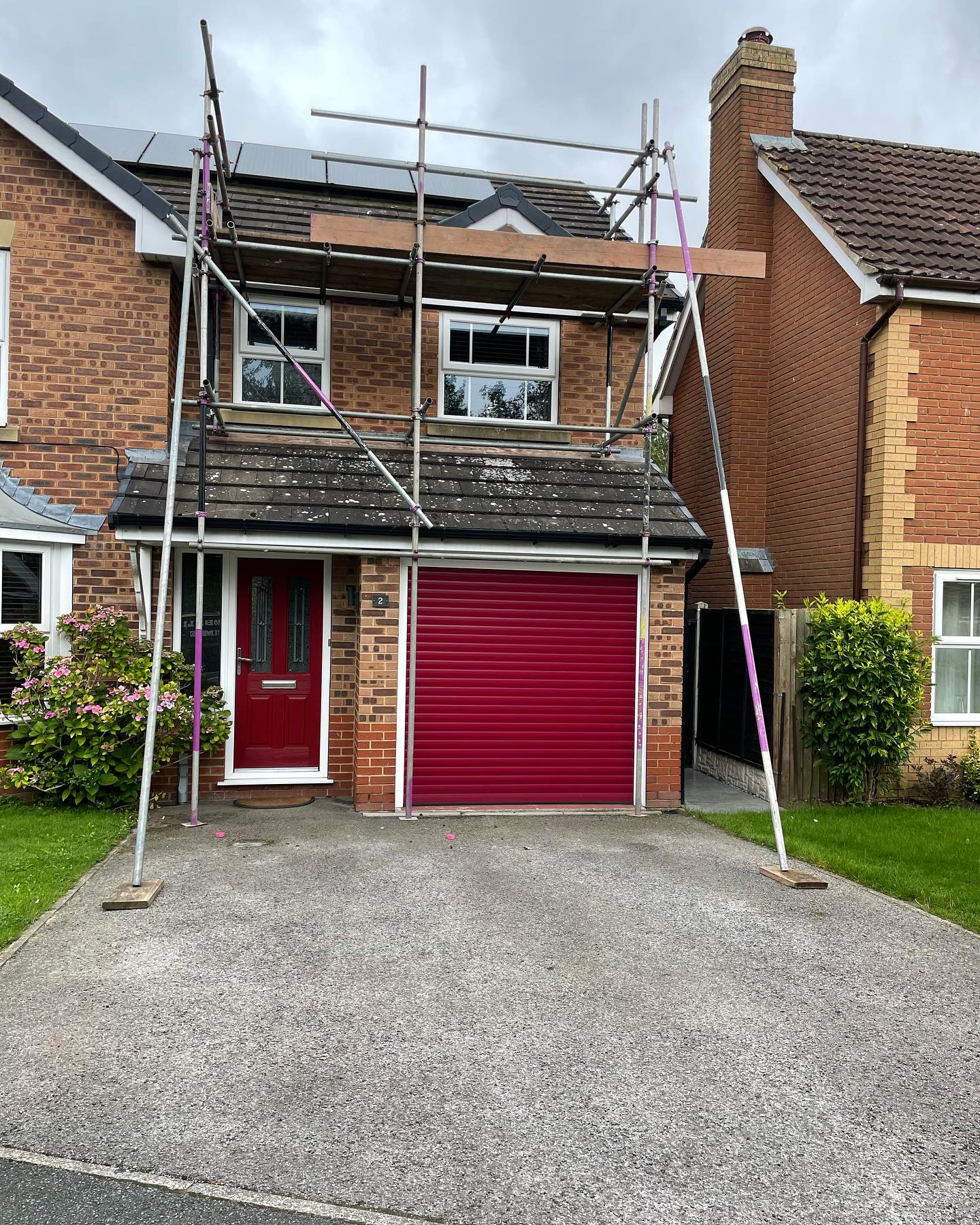 Detached family home with scaffolding for roof and chimney works
