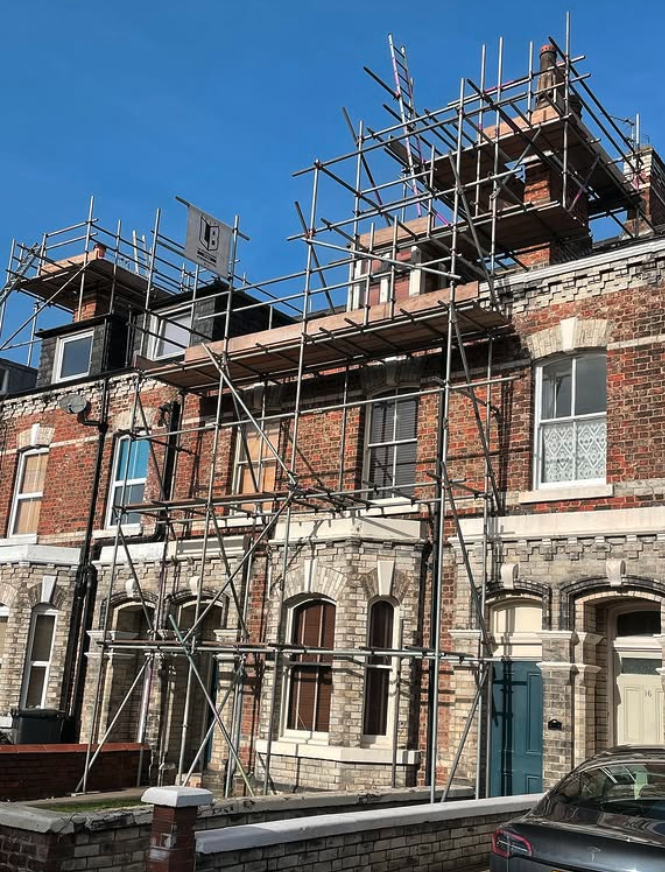Victorian terrace in York with scaffolding for roof and stonework